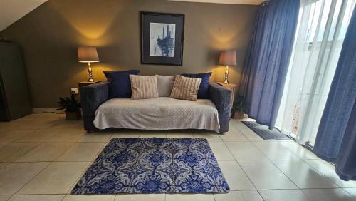 a living room with a bed and a rug at Belle Vie Boutique Guesthouse in Pretoria