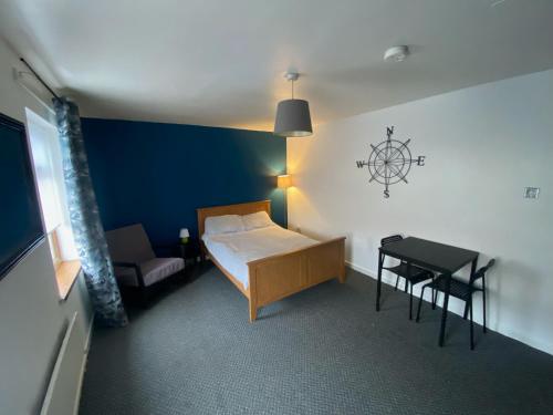 a small room with a bed and a table at bnb81 in Belfast