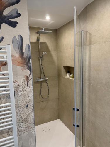 a shower with a glass door in a bathroom at MARIAS in Senj