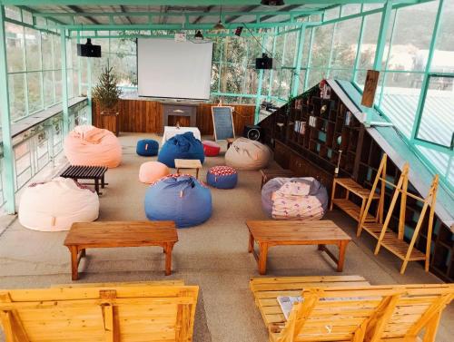 a room filled with lots of bean bags and benches at Dreamers Garden Farmstay in Hoat