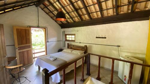 a small room with a bed and a window at Chalé Topázio in Ouro Preto
