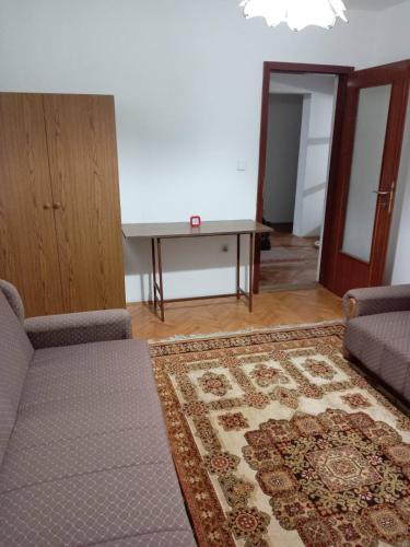 a living room with a couch and a table at Sobe Iskra 2 in Kučevo