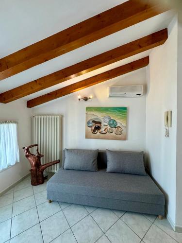a bed in a room with a wooden ceiling at Open space centre in Lignano Sabbiadoro