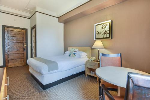 a hotel room with a bed and a table and a chair at Moore Hotel in Seattle