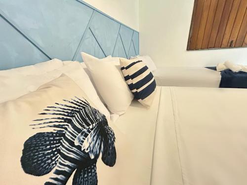 a bedroom with a bed with a stuffed animal on it at Pousada Oceano Atlântico in Marau