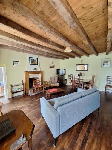 a living room with a couch and a table at Gite Ker Maria Gite Ker Louis Piscine in Saint-Gravé