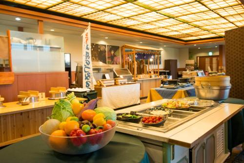 a buffet with a bowl of fruit on a counter at Tsurugi Koizuki in Kamiichi
