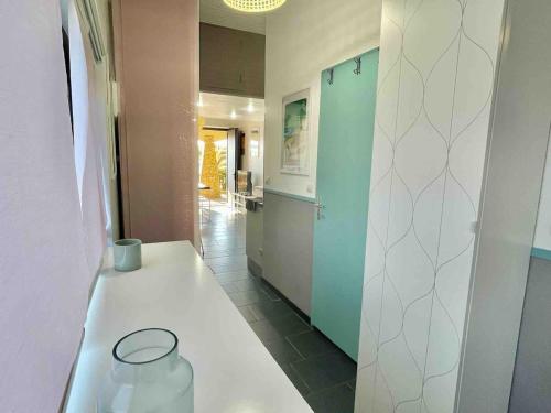 a kitchen with a table with a vase on it at Appartement Seignosse bord de plage in Seignosse