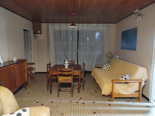 une pièce avec une table et un lit et une table et des chaises dans l'établissement PROCHE DE LA NATURE, à Mimizan