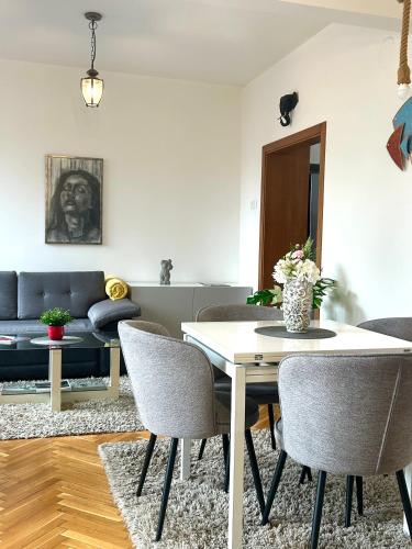 a living room with a table and chairs at Apartment DOLCE CASA in Varna City
