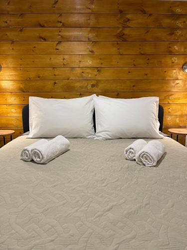 a bed with towels on it with two pillows at Villa Sunrise in Agia Paraskevi