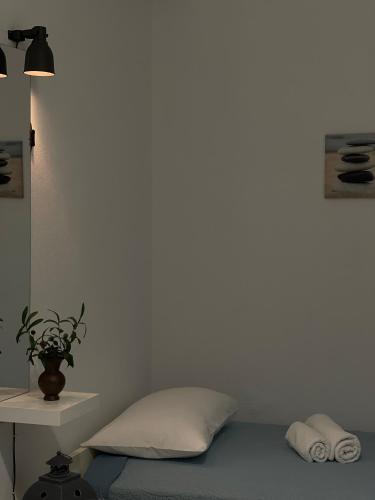 a bedroom with a bed and a white wall at Villa Sunrise in Agia Paraskevi