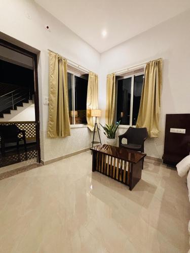 a living room with a couch and a table at Hariom Tatsat Retreat in Pushkar