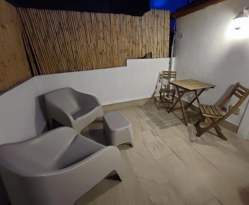 bagno con servizi igienici, tavolo e sedie. di La Vanedda apartment a Siracusa