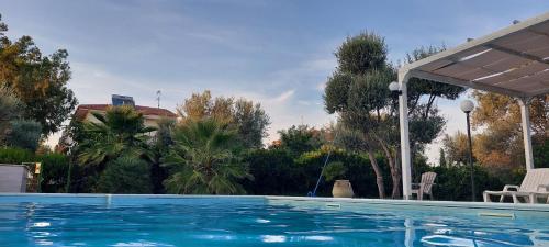 a swimming pool in a yard with at Il Casale Le Tre Volte in Solfara Mare