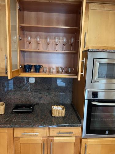a kitchen with wooden cabinets and a stove top oven at casa habana in Carballino