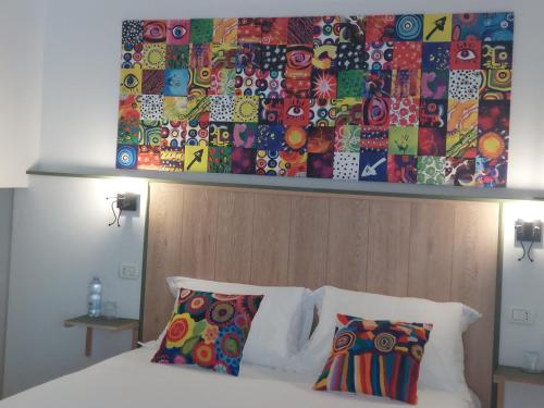 a bedroom with a bed with a wooden head board at Elmas Room in Elmas