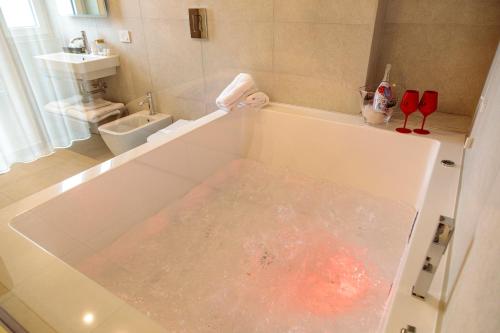 a bathroom with a bath tub filled with water at Domus Vivian in Montecorvino Pugliano