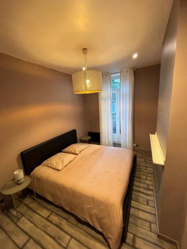 a bedroom with a large bed and a window at T2 cosy proche commodités in Marseille