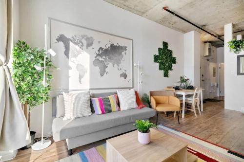 a living room with a couch and a world map on the wall at Eminence Sleek Studio City View in Edmonton