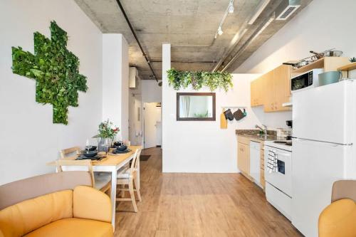a kitchen and dining room with a table and chairs at Eminence Sleek Studio City View in Edmonton