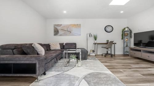 a living room with a couch and a television at Winston Suite 2BR 1BA - Carriage Suite with Garage in Calgary