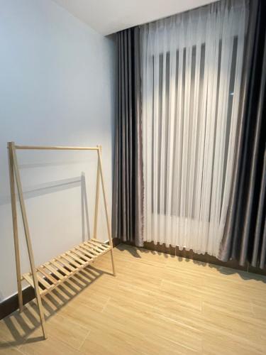 a room with a bed and a large window at Experience Homestay in Can Tho
