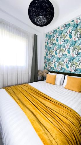 a bedroom with a large bed with a yellow blanket at Appartamento Fronte al Mare in Tangier