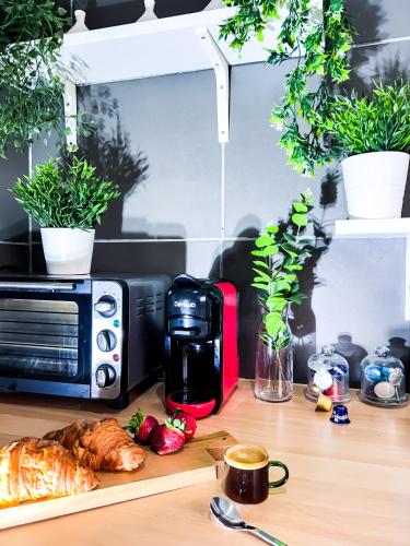 a kitchen counter with a toaster oven and a table with food at Appartamento Fronte al Mare in Tangier