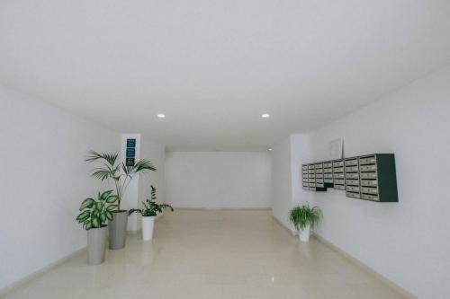 a white room with potted plants and a wall at SeaSide Haven in Split