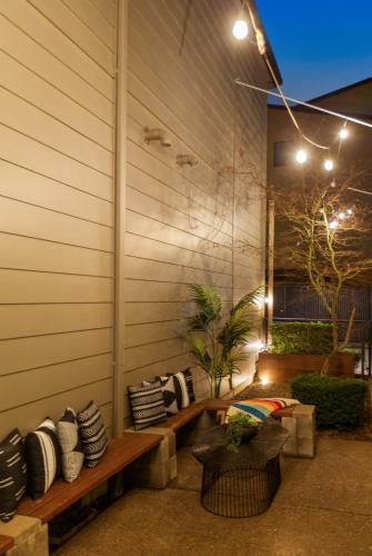 a patio with a bench and pillows on a wall at THE PENDLETON - Walkable - Arcade Loft - Modern- Light & Bright in Eugene