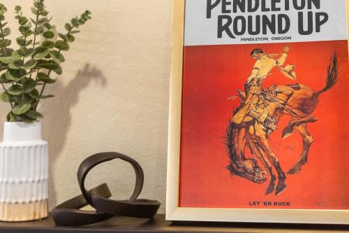 a poster of a woman riding a horse on a table at THE PENDLETON - Walkable - Arcade Loft - Modern- Light & Bright in Eugene