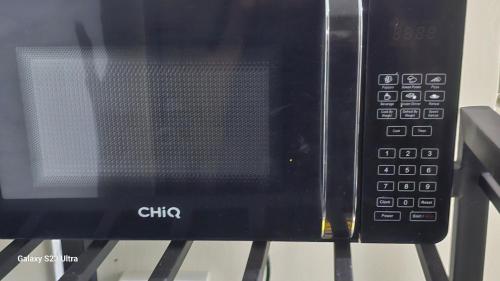 a microwave oven sitting on top of a table at The Rocky Apartment in Namulanda