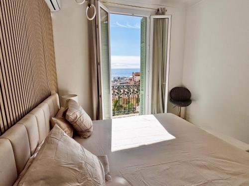 une chambre avec un lit avec vue sur l'océan dans l'établissement Appartement vue mer vue Monaco, à Beausoleil
