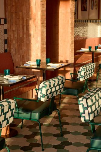 a restaurant with tables and chairs in a room at SLS Barcelona in Barcelona
