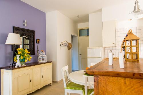a kitchen with a table and a dining room at Eva's House in Stroumbi