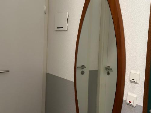 a mirror in a bathroom with a surfboard in it at Moderne und komfortable Appartements im Ferienpark Hahnenklee in Hahnenklee-Bockswiese