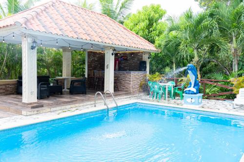 a house with a swimming pool and a gazebo at Rancho Juliana in Villas del Mar