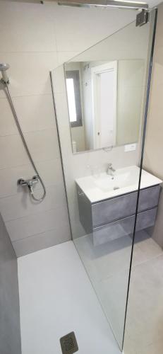 a bathroom with a sink and a mirror at Chilches Sunset Beach in Vélez-Málaga