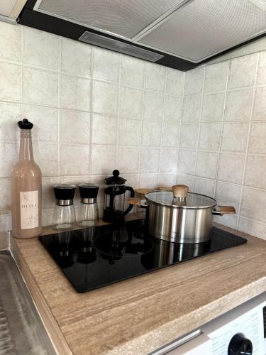 a pot on top of a stove in a kitchen at Lupin Fodele Home near the beach in Fodele