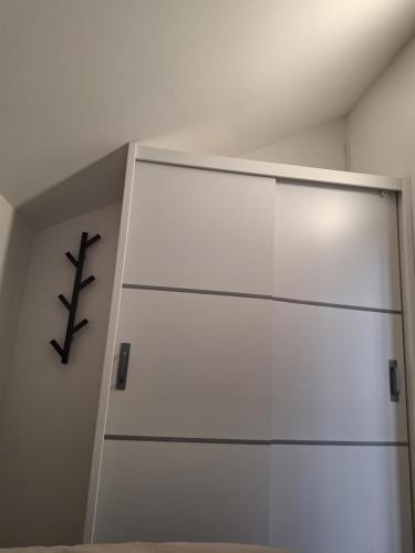 a white closet with a sliding door in a room at Spa Cottage the Moon house Terme Čatež in Čatež ob Savi