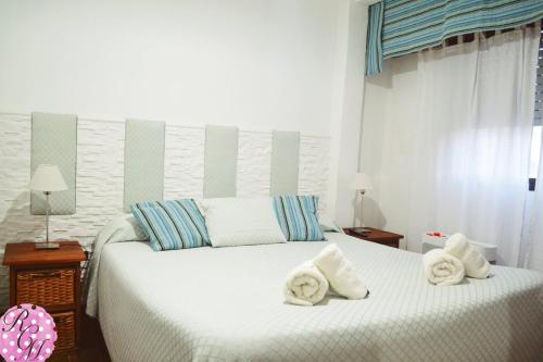 a bedroom with two beds with towels on them at Rocio Club de Mar in Mar del Tuyú
