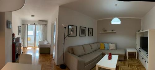 a living room with a couch and a table at APARTMENT CENTRAL No 5 in Apatin
