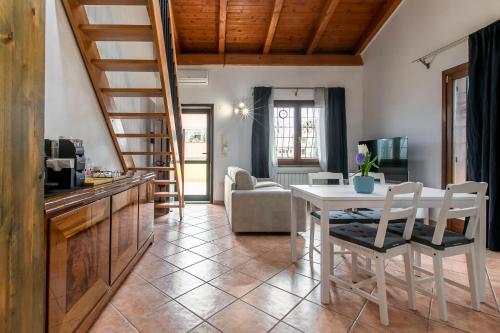 a kitchen and living room with a table and chairs at Morning Glory in Fiumicino