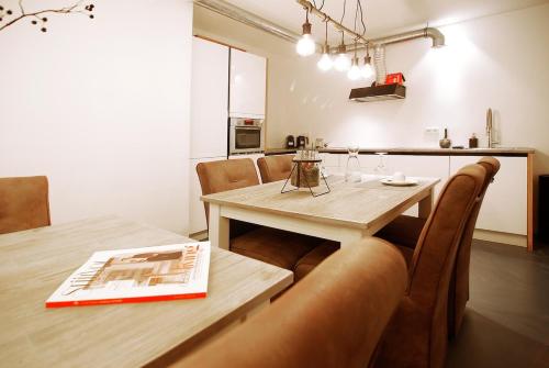 a dining room with a wooden table and chairs at Two Tulips Inn Dutch Retreat in Hillegom