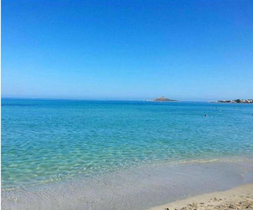 a large body of water with a sandy beach at DV holiday home in Isola delle Femmine
