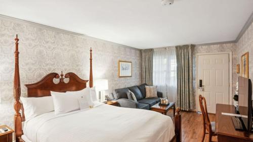 a hotel room with a bed and a couch at Avon Old Farms Hotel in Avon