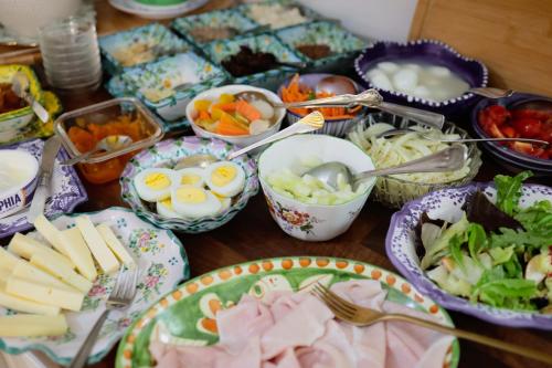 a table topped with bowls and plates of food at Hotel Villa Verde in Ischia