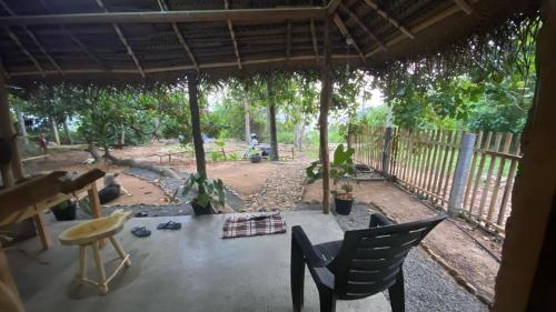 a view of a patio with a table and chairs at RURAL CLAY HOUSE Hiriketiya in Hiriketiya