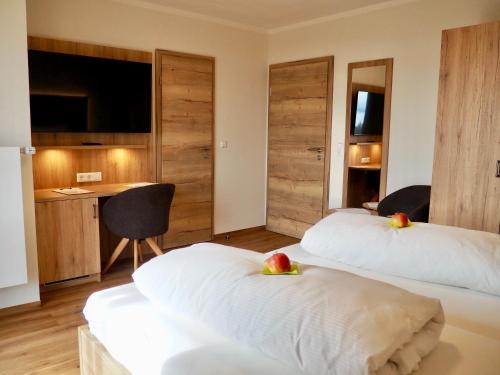 a hotel room with two beds with fruit on them at Privatpension Eva in Hagnau